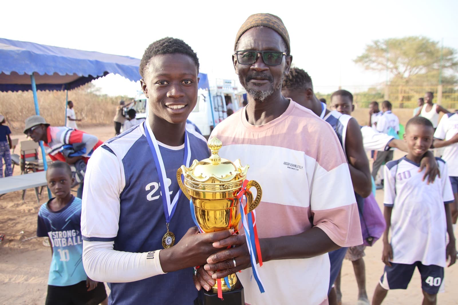 Yakaar FC player receiving recognition after football